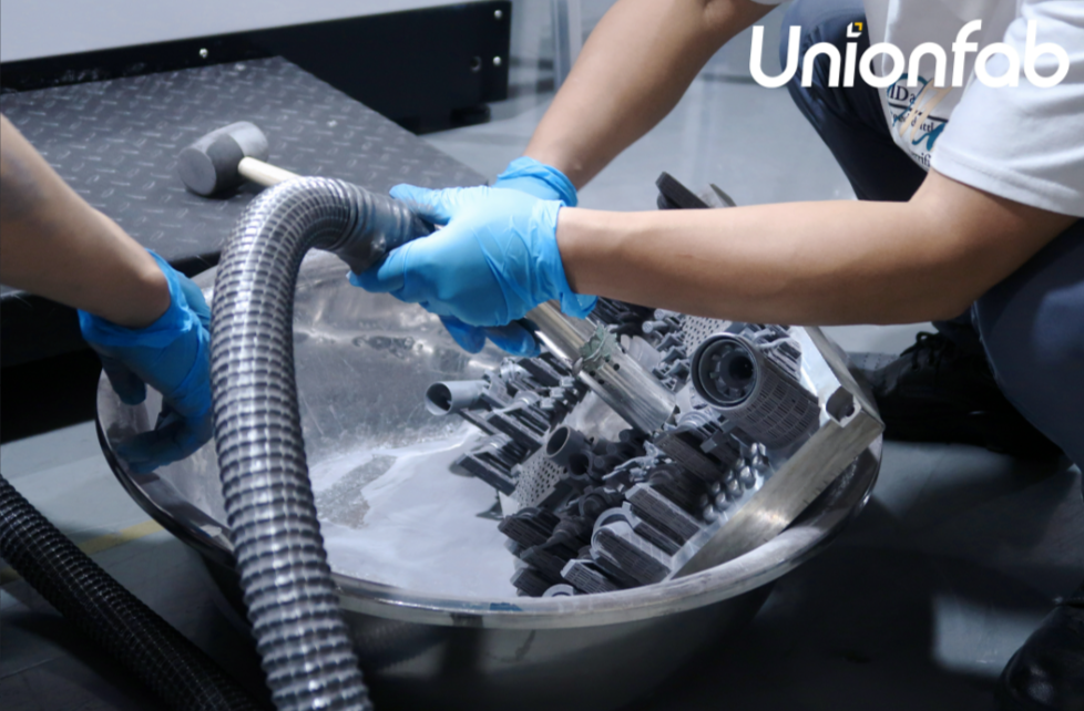 Clean removal of support structures and surface refinement using powder blasting techniques